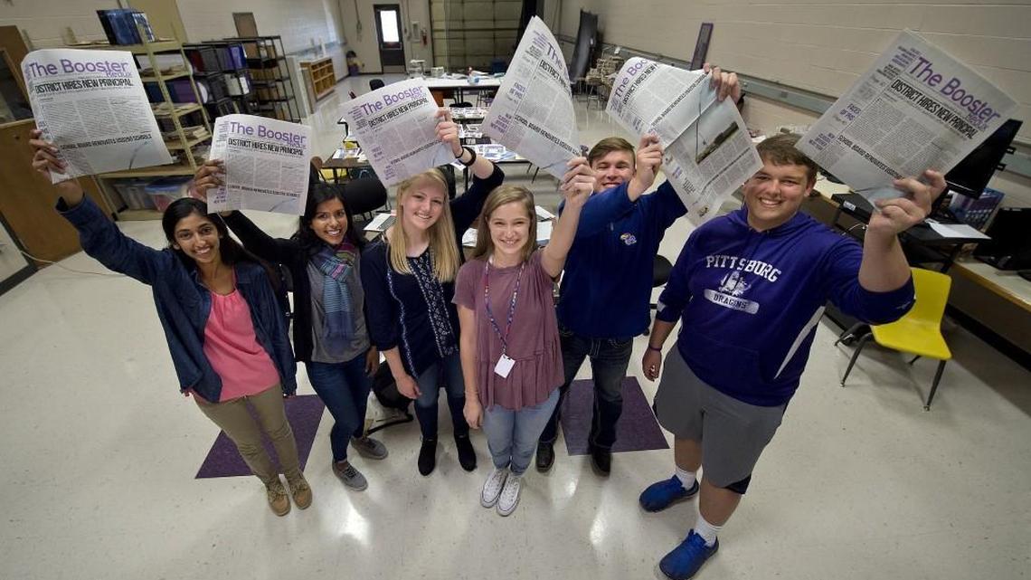 Pittsburg High School student journalists Trina Paul (from left), Gina Mathew, Kali Poenitske, Maddie Baden, Patrick Sullivan and Connor Balthazor held up copies of The Booster Redux containing their article that led to the resignation of the school’s newly hired principal.