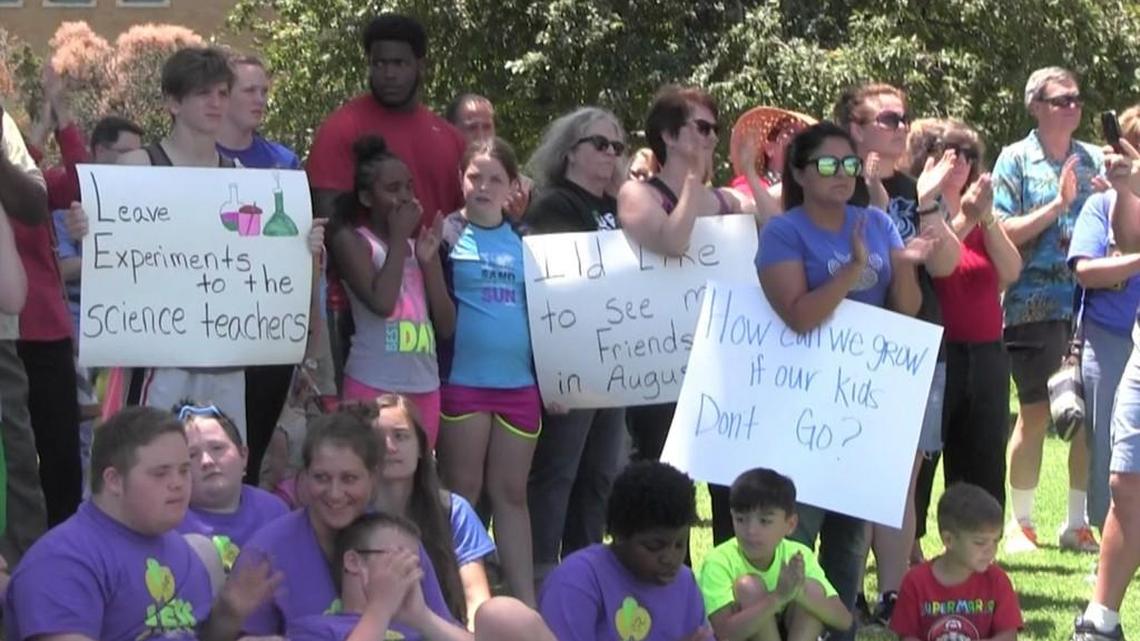 Teachers and students gather on the lawn outside North High School on Tuesday afternoon for a United Teachers of Wichita rally calling for lawmakers to fix school finance inequities. (June 7, 2016)