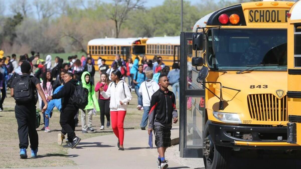Stucky Middle School students board buses to leave school for the day. Wichita school officials are looking at several options to cut down on transportation costs. (March 24, 2016)