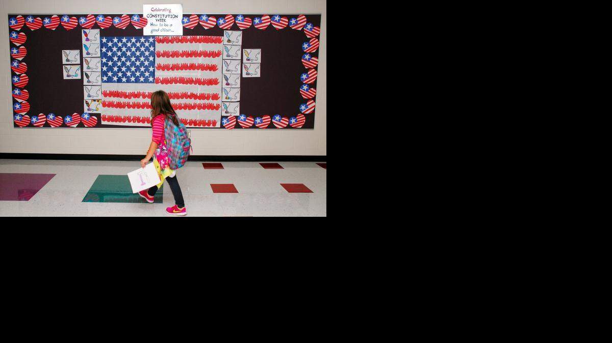 
A student heading to class at Explorer Elementary School in Goddard passes by a mural dedicated to the Constitution. Students in Pam Hofmeier‘s second-grade class have been adding the rights granted by the Constitution. 
