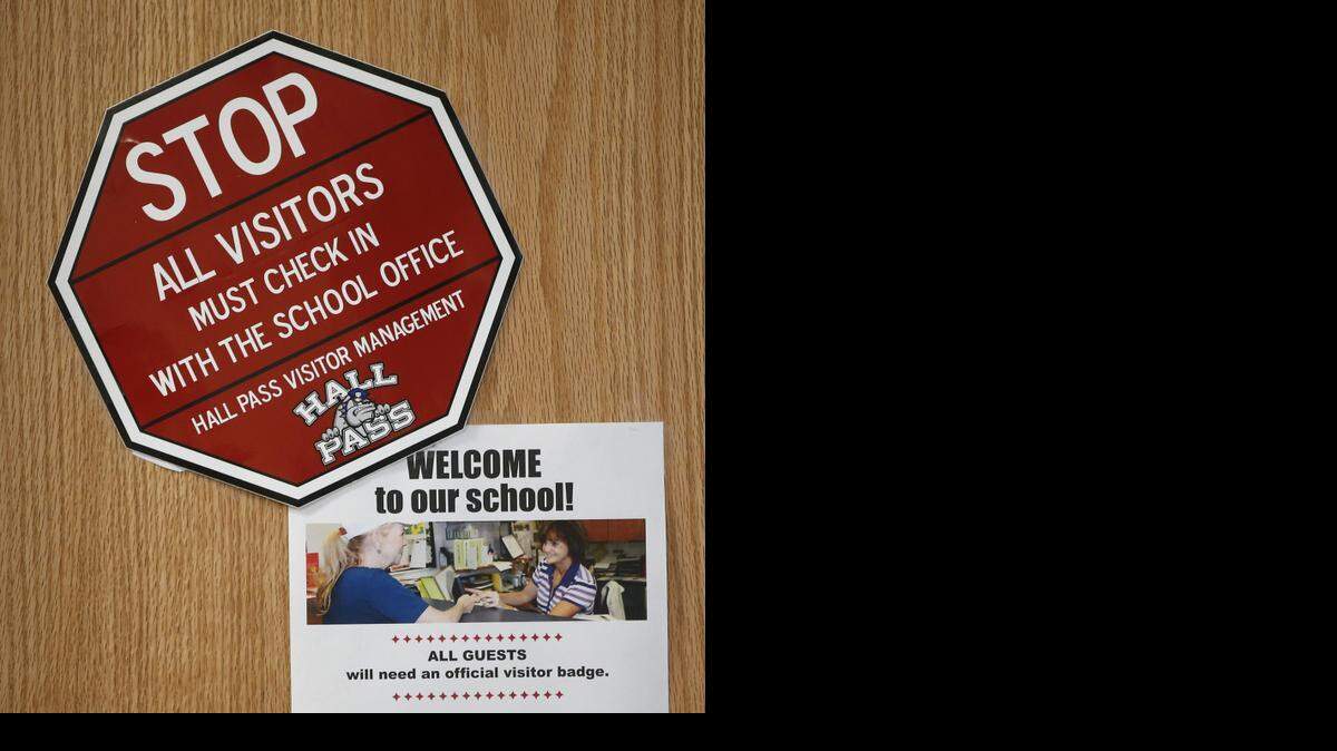 
A warning at Christa McAuliffe Academy to visitors that they have to check into the school using the Hall Pass system. The system checks the identification of every visiting adult who goes into the school against a sex offender database. (Aug. 21, 2014)
