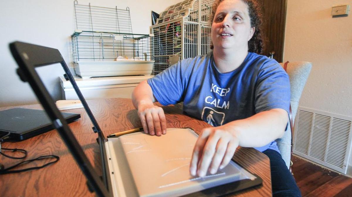 Blind Wichita State pre-med student Emily Schlenker uses her Tacti-Pad that WSU provided at her east Wichita apartment Thursday. She recently settled a civil rights complaint with the school that resulted in an agreement for the university to do a better job in accommodating visually impaired students. (Aug 18, 2016)