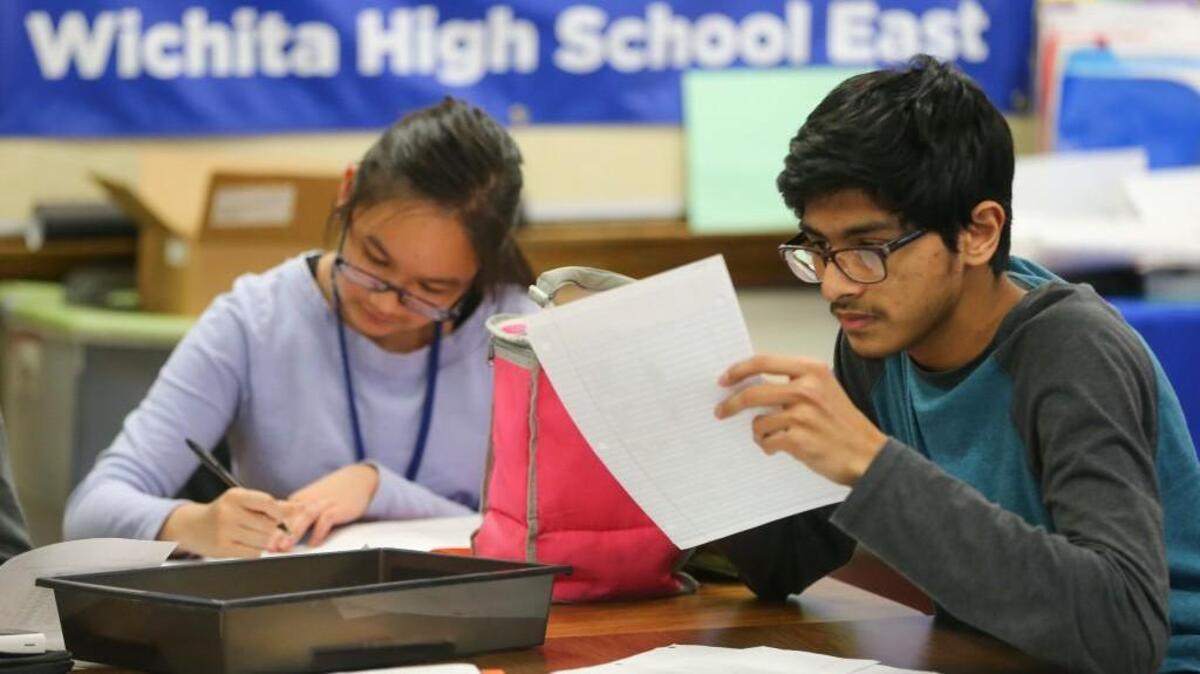 Syed Shamiun, right, and Vivian Pham take part in an International Baccalaureate course at Wichita East High School in February.