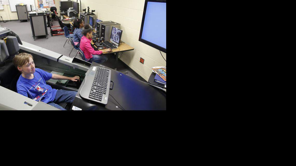 
Ian Bench sits in a jet simulator at Wichita’s Mueller Elementary School on Wednesday. Mueller is about to get some out-of-this-world playground equipment: a NASA-grade lunar rover, Mars rover, space plane and space station module. This fall, the aerospace and engineering magnet school near 18th and Grove will be the first school in the country to launch the NASA-inspired Space Discovery Institute program, which gives students hands-on experience with aerospace technology. (April 8, 2015)
