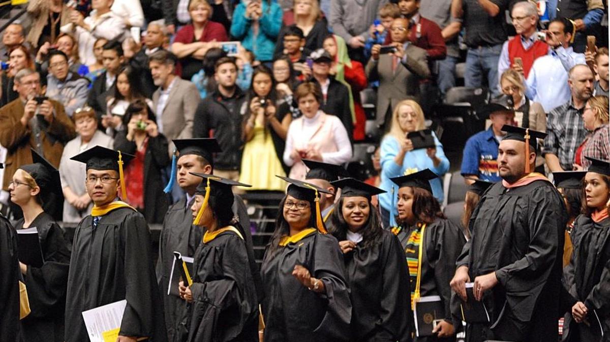 Graduates enter Charles Koch Arena on Sunday for the fall 2015 Wichita State University graduation. (Dec. 13, 2015)