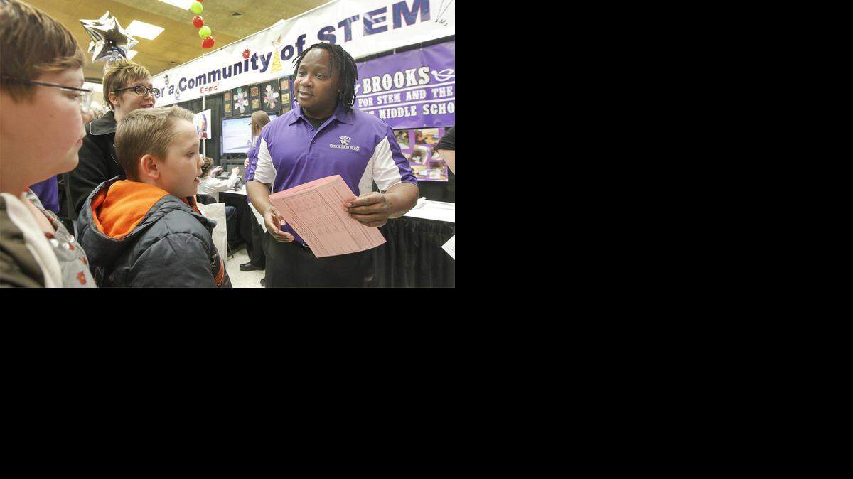 
A representative with Brooks Middle School Center for STEM and the Arts, right, talks with students interested in his school during the Choices Fair at Century II in January. (Jan. 30, 2014) 
