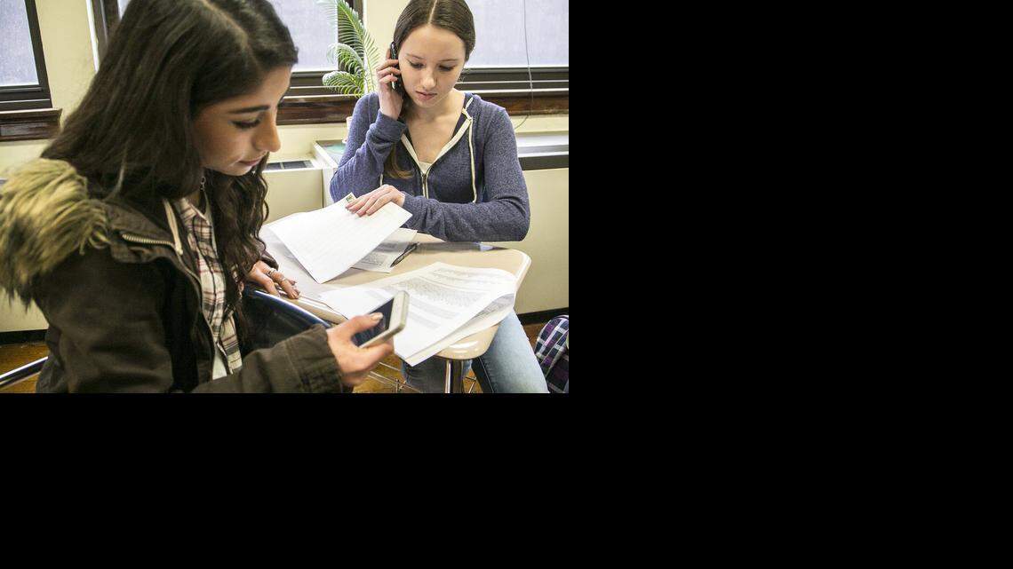 
East High junior Parnia Razi, left, and sophomore Emma Kuttler join other students over lunchtime Friday for a phone/e-mail campaign against Senate Bill 56, the measure just approved in the Kansas Senate that would make it easier to charge and prosecute teachers for distributing harmful material to minors. (Feb. 27, 2015)
