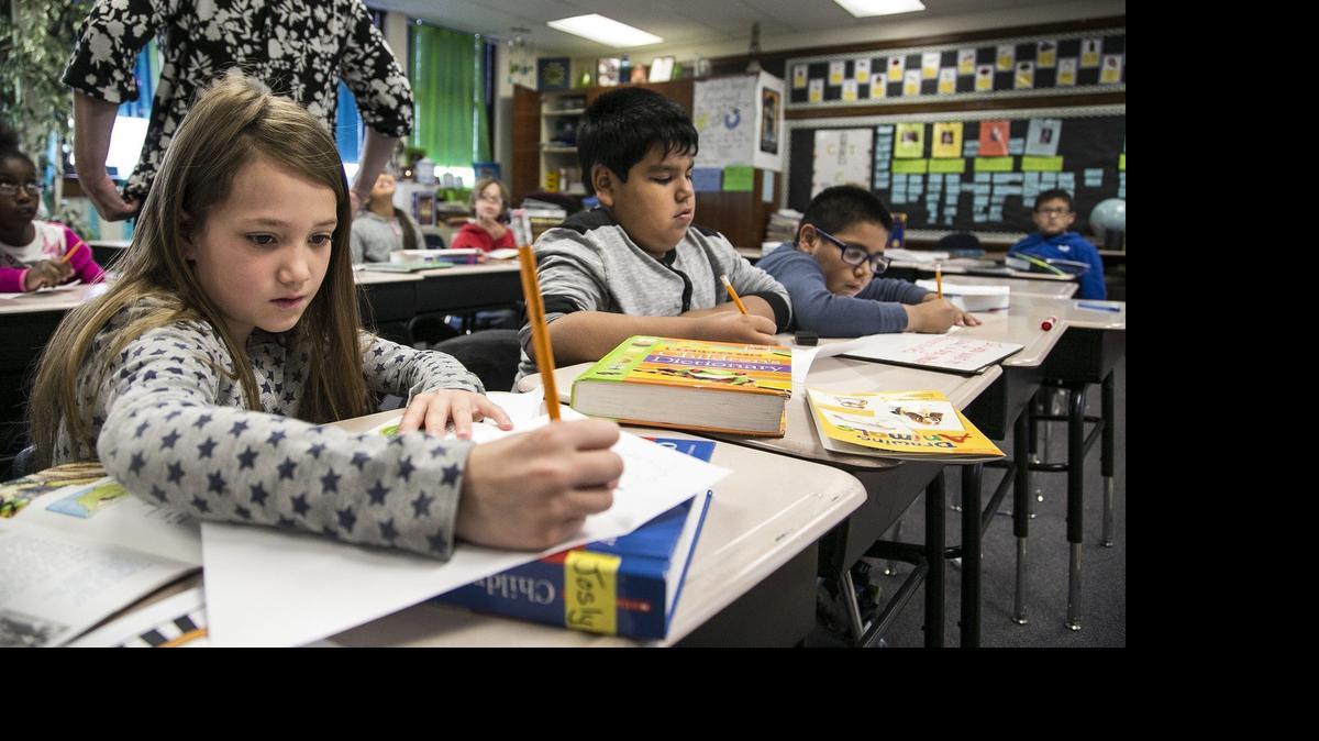 
Harry Street Elementary third-graders Joslyn Campbell, Jesus Garcia, center, and Isaac Durban work on a book project. United Way of the Plains has issued a grant to Communities in Schools of Wichita/Sedgwick County as part of its Westside Promise Neighborhoods initiative. (May 19, 2015)

