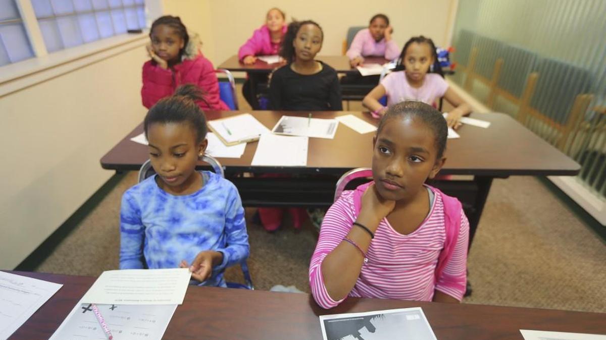 Students work to solve math problems at Katherine Johnson Scholar Sisters, a group formed to get female elementary students interested in STEM subjects. They meet twice a week for advanced learning on math and other STEM subjects.