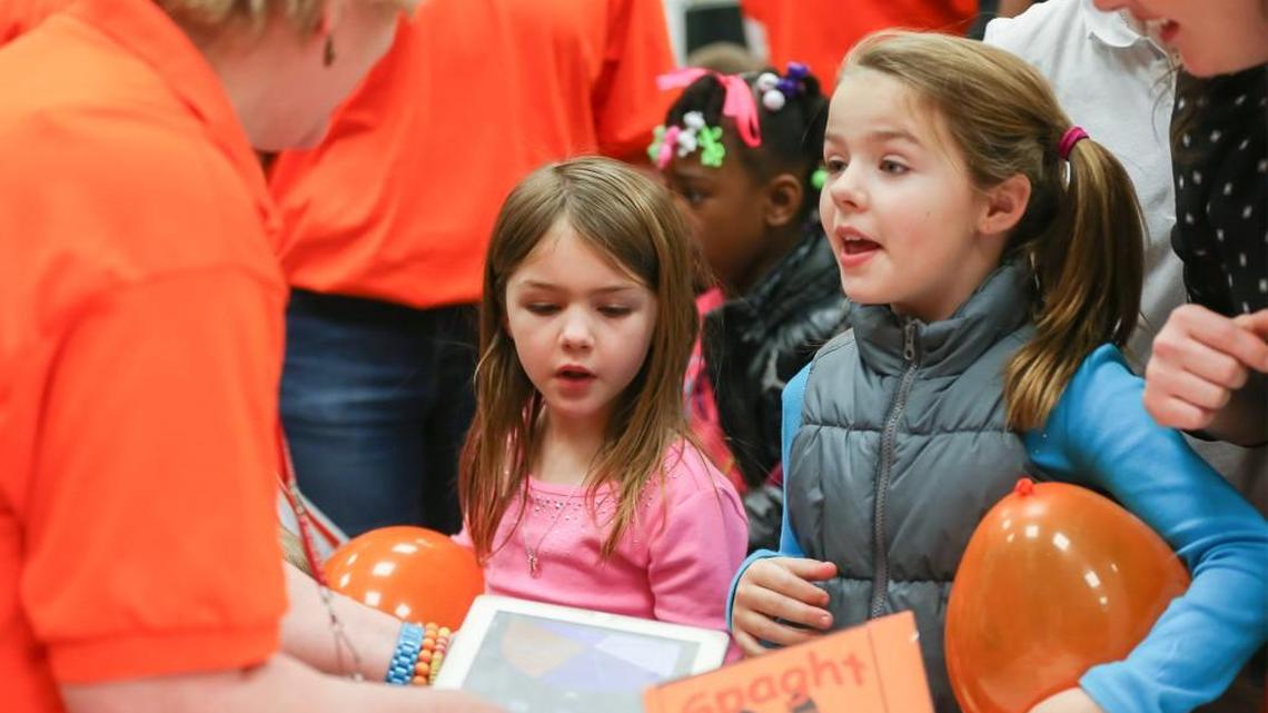 Alyssa Green, 8, right, and her sister Sadie, 6, visit with a representative at the Spaght Elementary booth at the Choices Fair in 2014.