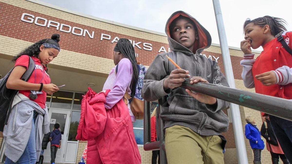 Children wait for rides as school lets out at Gordon Parks Academy on Wednesday. A plan was recently presented to parents, community members and local black leaders to abandon the school’s IB certification. (March 29, 2017)