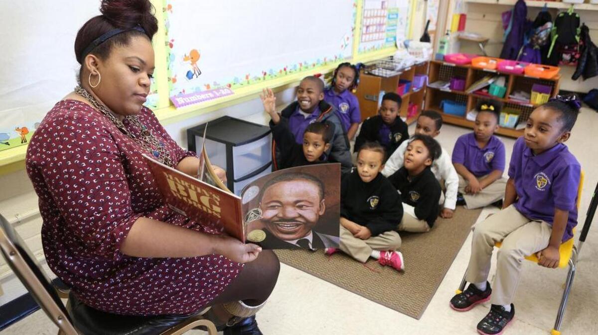 Teacher Madelene Moore reads a story about Dr. Martin Luther King Jr. to her kindergarten/second-grade class at Urban Preparatory Academy. The school is a K-6 private school in the old Mueller Elementary building in Wichita.
