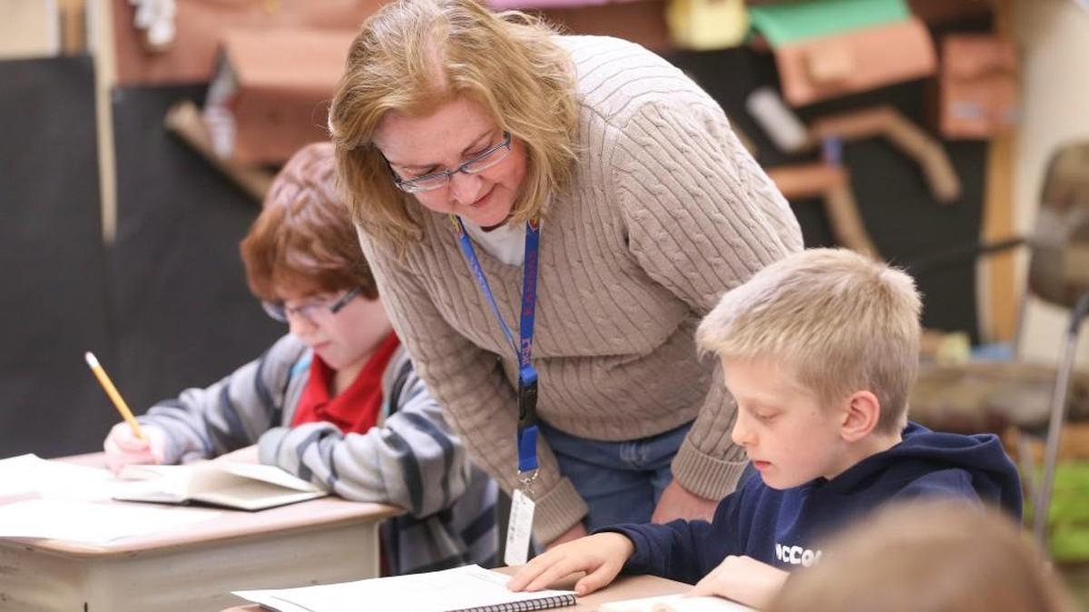 McCollom Elementary teacher Amy Lockman works with Thatcher Auten. (Feb. 9, 2016)
