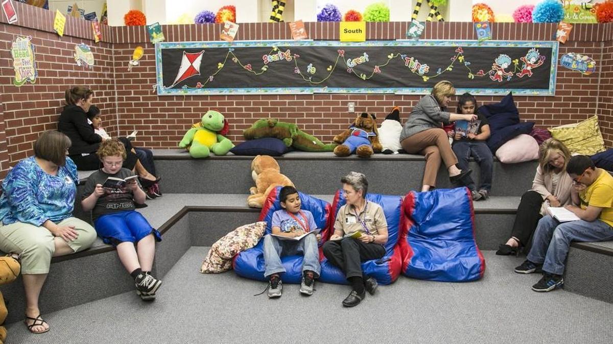 Members of United Way’s Women’s United, the Pando Initiative and First Wesleyan Church work one-on-one with third-grade students at Gardiner Elementary to help them become better readers and to also be role models. (April 28, 2016)