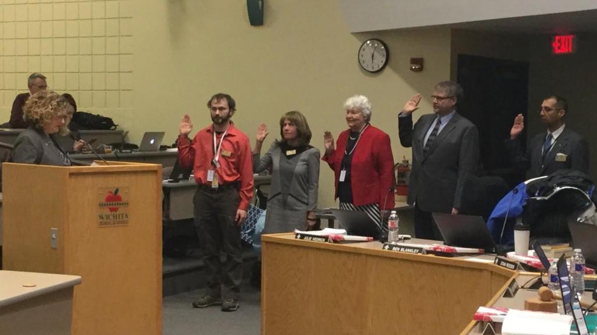 Sedgwick County Election Commissioner Tabitha Lehman, left, administers the ceremonial oath of office to new members of the Wichita school board: Ben Blankley, Julie Hedrick, Ernestine Krehbiel, Stan Reeser and Ron Rosales.