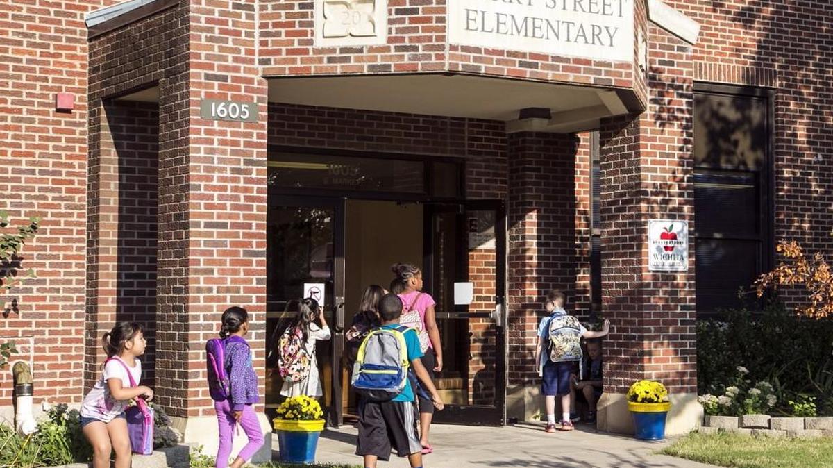 
Students arrive at Harry Street Elementary. United Way has launched its "Be There" campaign, aimed at reducing chronic absenteeism in Wichita schools. 
