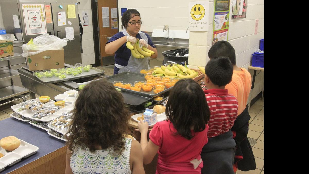 
Students at Gardiner Elementary School stand in line for fruit during their lunch hour. Wichita school district officials have opted out of a program to serve free meals to all students at a school.

