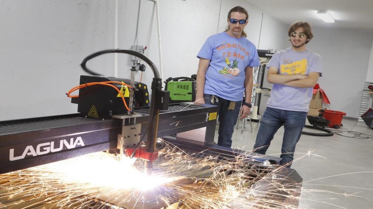 Wichita Collegiate teacher John Bullinger along with one of his students watches as a computerized plasma cutter cuts out a pattern. Wichita Collegiate has installed a new innovation lab that includes 3-D printers, a CNC router machine and a plasma cutter for students to learn to operate and use for their creations. (Oct 21, 2016)