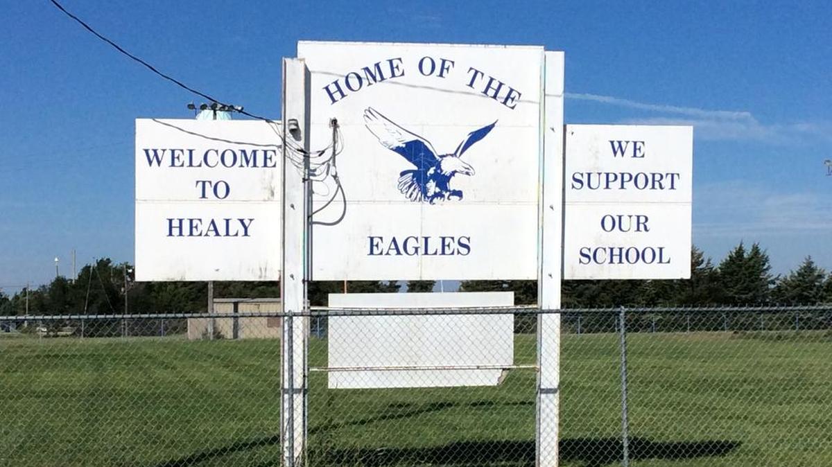 As one drives into Healy, population 230 residents, the school and reminders of it are never far from view.