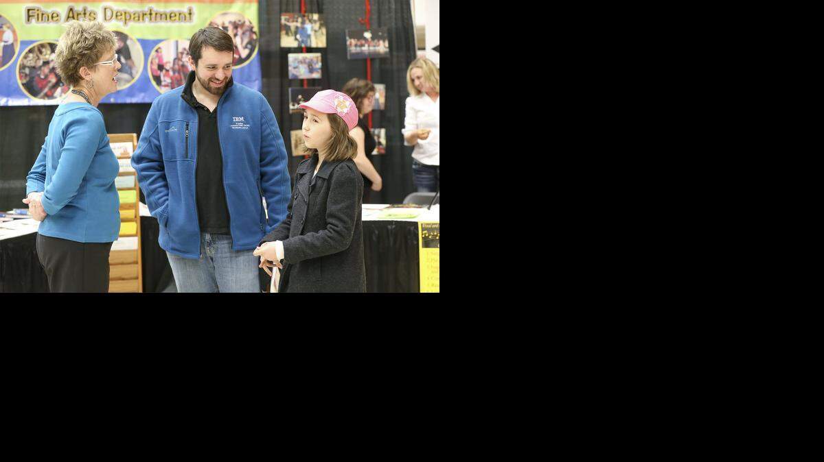 
Jonathan Callstrom, center, and his daughter Elseigh, 8, right, talk with vocal music curriculum coach Holly Taylor at the Choices Fair at Century II. (Jan. 30, 2014)
