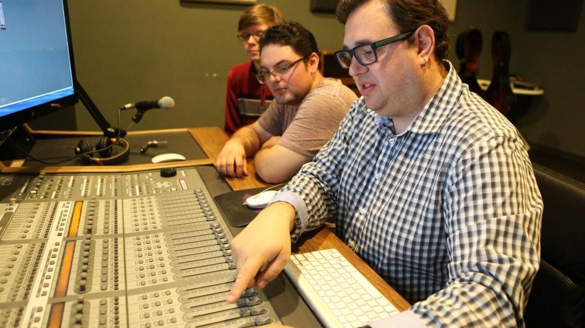 Aleks Sternfeld-Dunn, right, an associate professor at Wichita State University, shows Nelson Spaulding how to use Pro Tools, an audio editing and recording program. WSU soon will offer a new degree in media arts. (April 25, 2017)