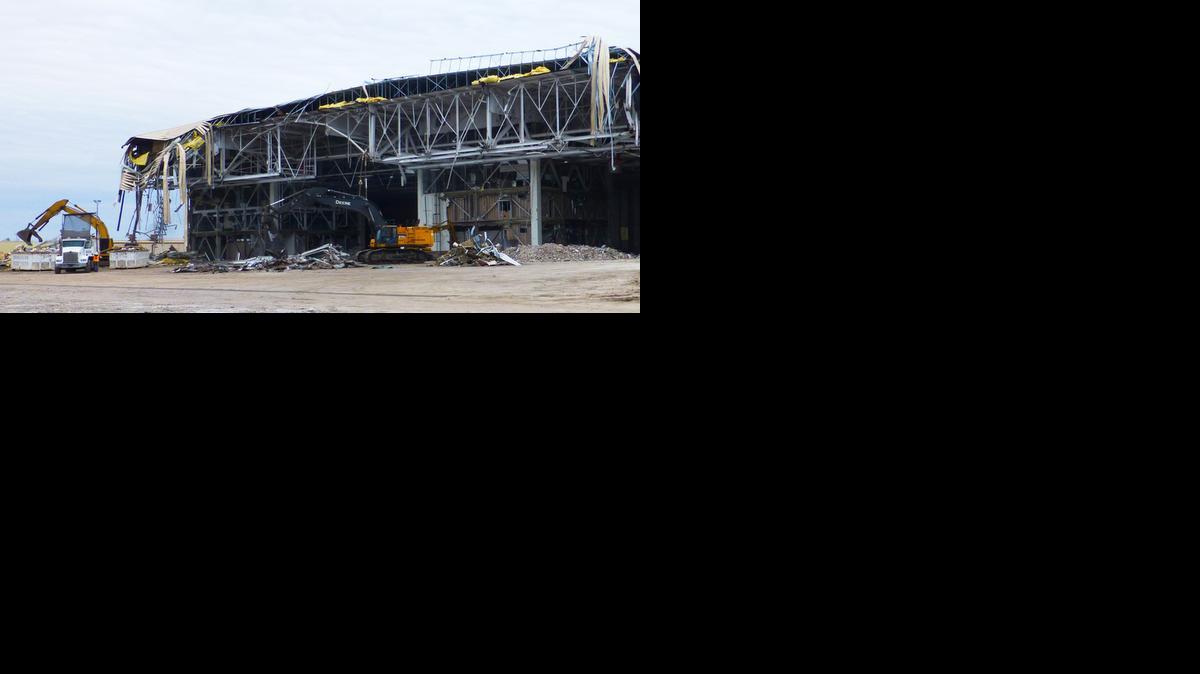 
Demolition crews tear down an old hangar at McConnell Air Force Base to make way for a new three-bay hangar. It will be one of three new hangars at the base used to accommodate the new KC-46 refueling tankers.
