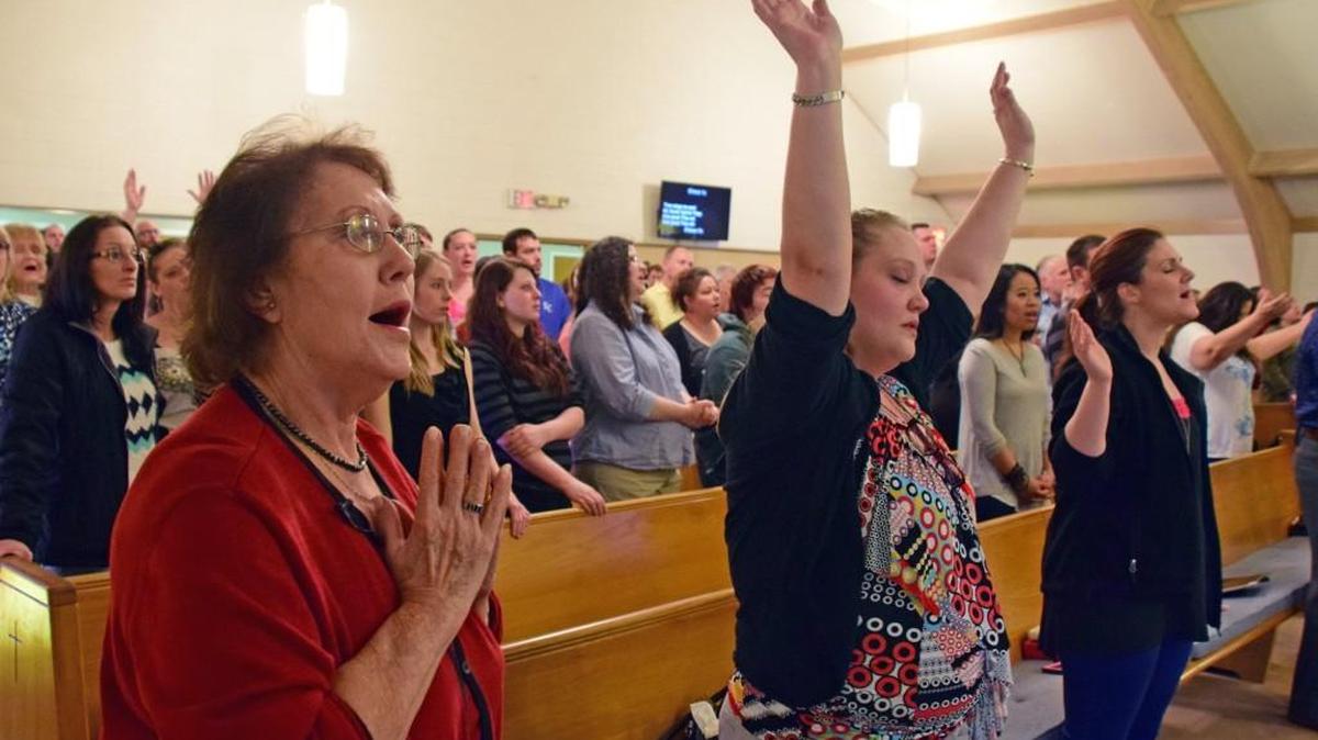 Worshipers from Mending Place Church and South City Baptist Church open the service Sunday as the two churches merged.