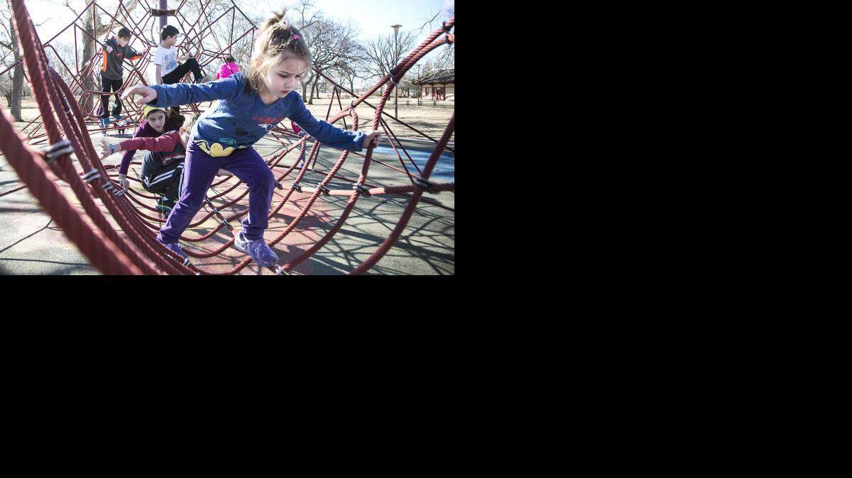 
Avalyn McClure, 4, joins other kids on the rope jungle gym Monday in Riverside Park.  (Jan. 19, 2015)
