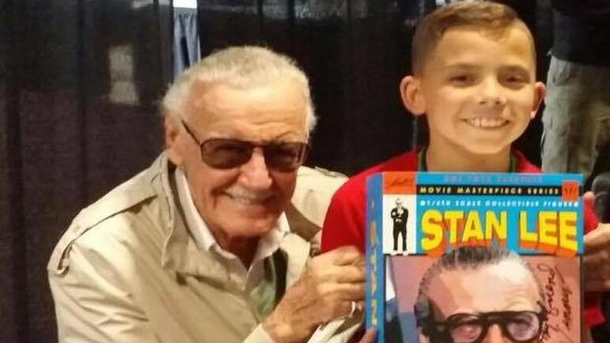 Vincent Manning, right, 9, receives a Stan Lee figure from the comic book legend himself at Planet Comicon. Lee autographed the one-of-a-kind figure that has not yet been released in the U.S.