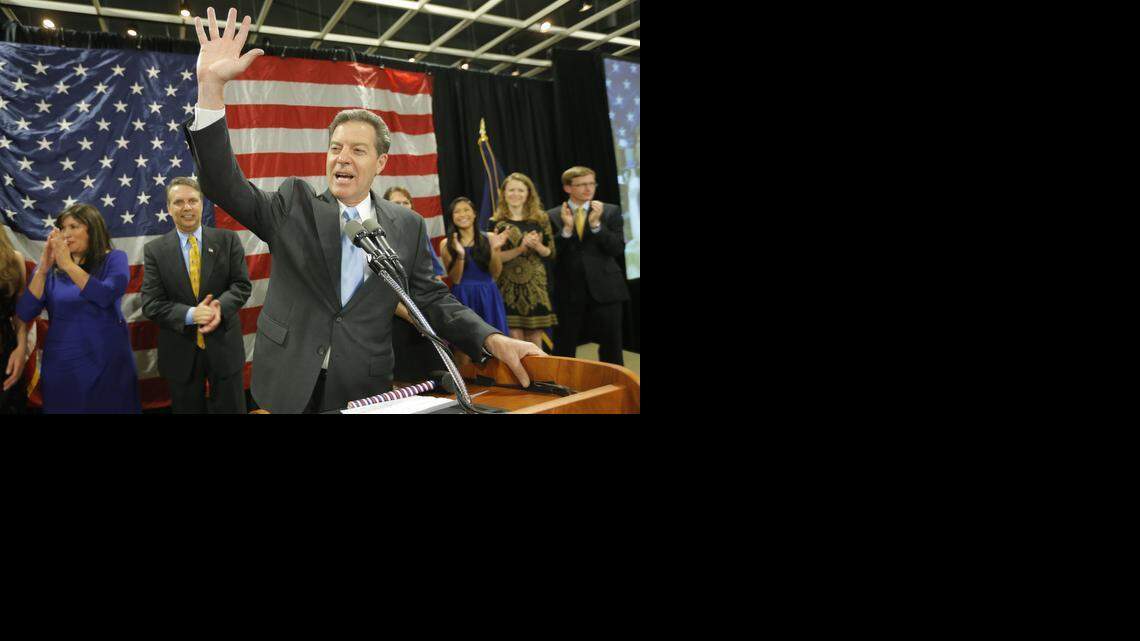 
Sam Brownback waves to a cheering crowd in Topeka after he was reelected governor on Tuesday after a close race against democrat Paul Davis.
