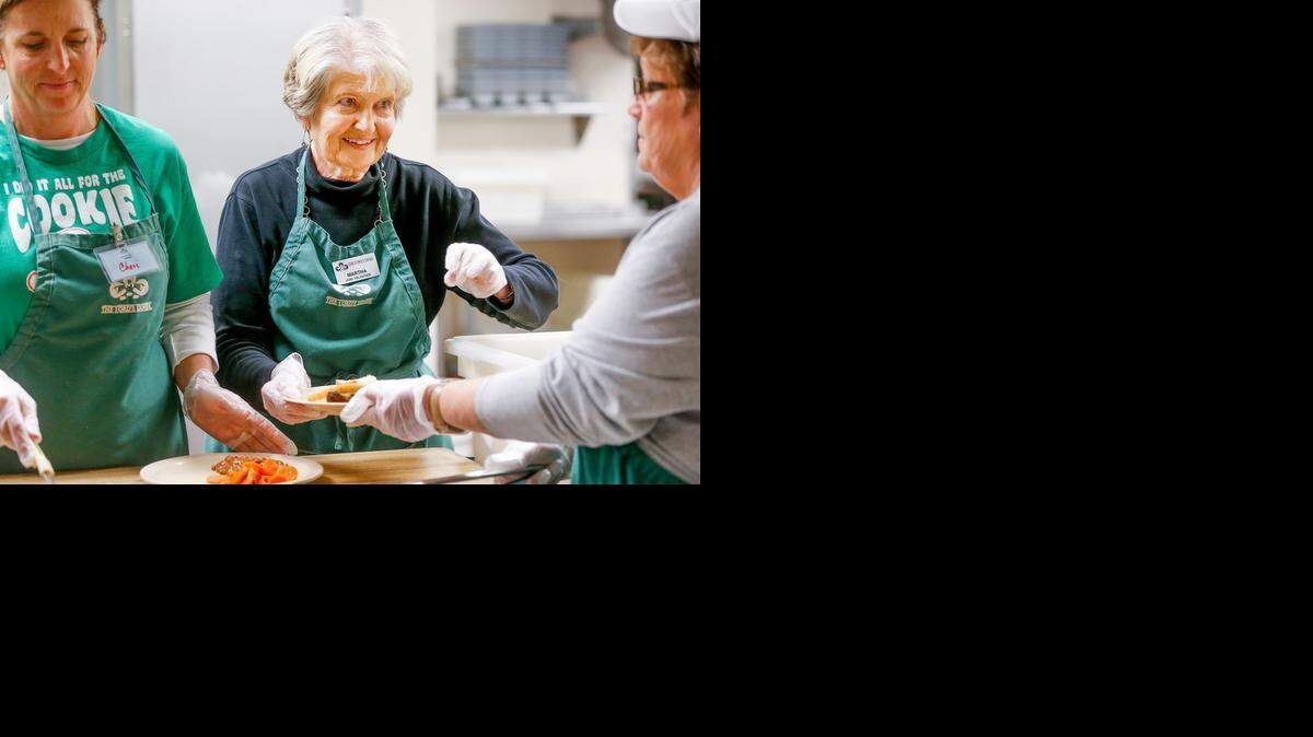 
Martha Lewis , center, volunteers recently at the Lord’s Diner. (Dec. 23, 2014)

