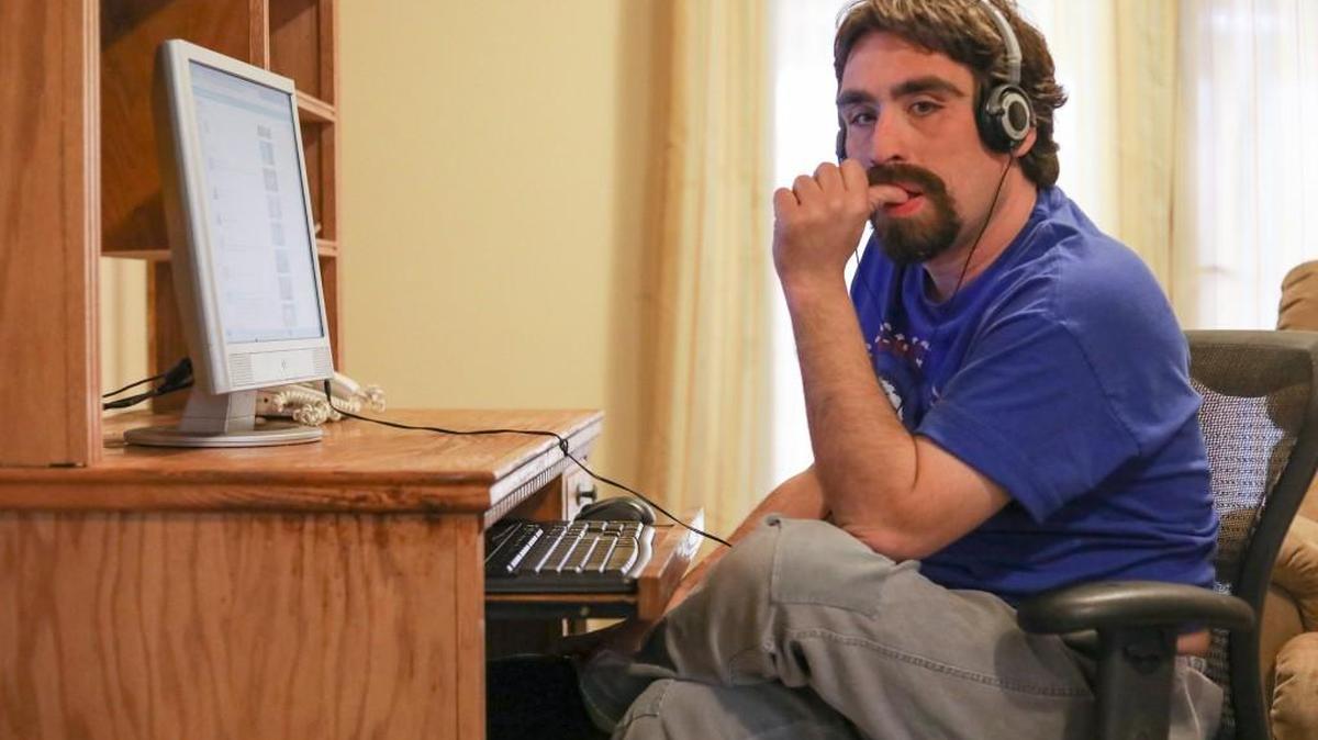Zach Soltz surfs YouTube on his computer in his home. Soltz has Fragile X syndrome and receives in-home support from a caregiver. He also participates in a day program. (March 8, 2017)