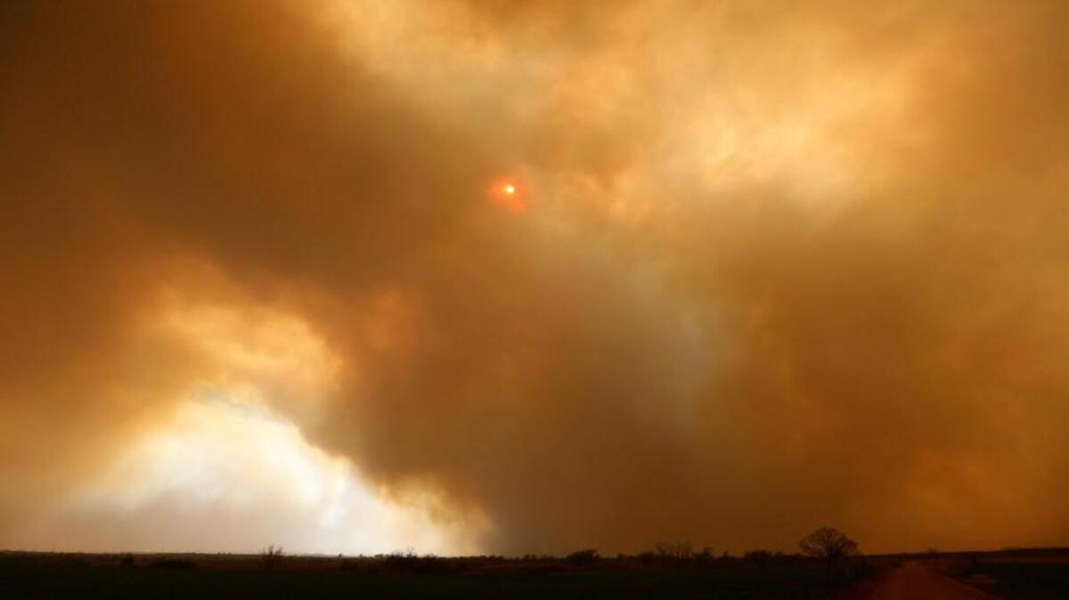 Smoke and blowing dirt obscure the sun near Medicine Lodge on Wednesday