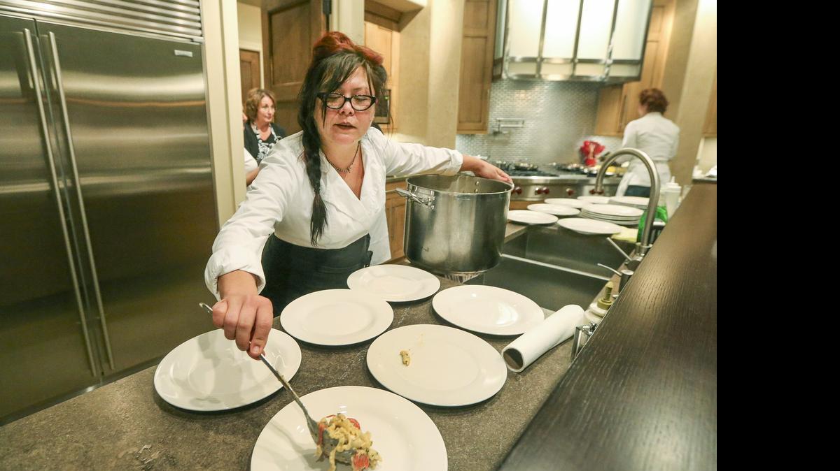 
Chef Tanya Tandoc serves up her Tomato Pasta with Brie Cheese at a fundraiser in east Wichita. (Sept. 30, 2014)
