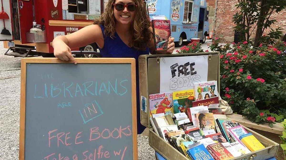Sara Dixon and other librarians with the Wichita Public Library occasionally visit the Pop-Up Urban Park on East Douglas to give away books and talk about what the library offers.