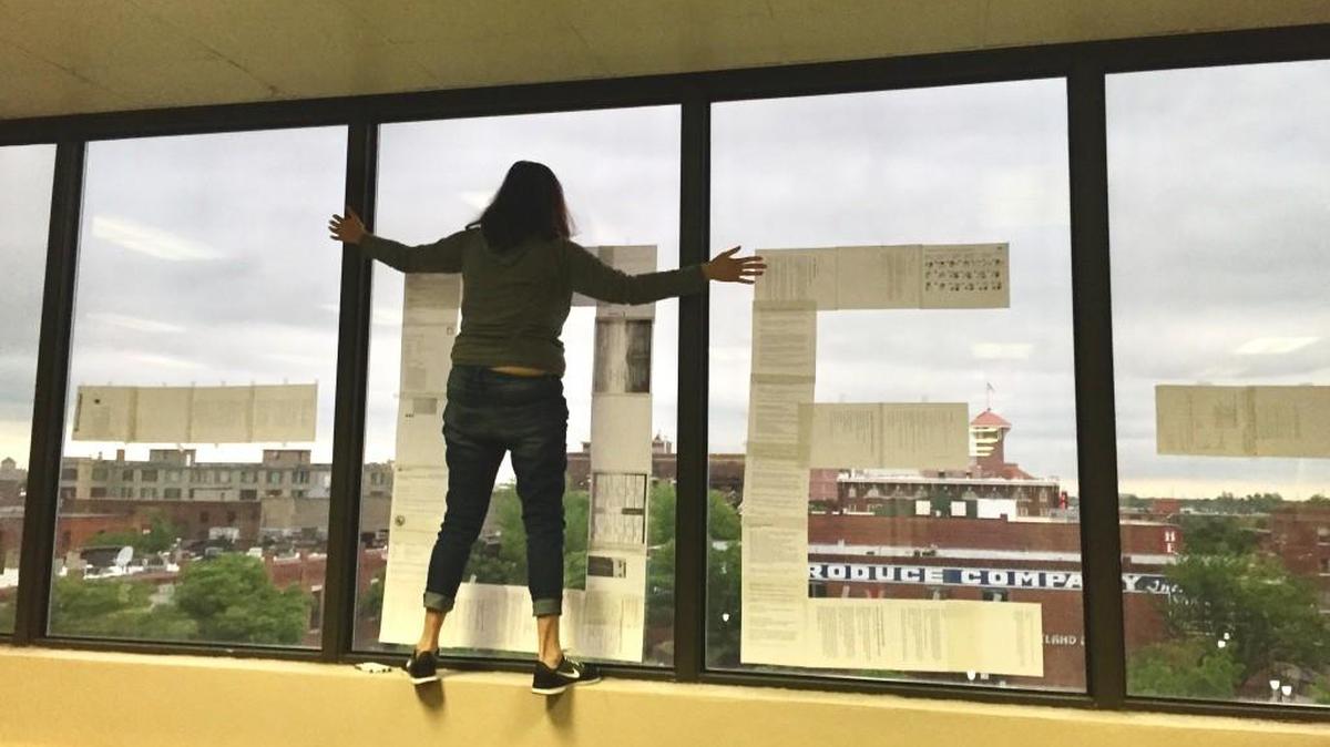 Video editor Jaime Green stands at the third-floor newsroom window on Friday, the last work day for the old Wichita Eagle building at 825 E. Douglas. In the window facing Douglas, staff members put up a -30-, the newspaper symbol for “the end.” But as we like to say, it’s a new beginning.