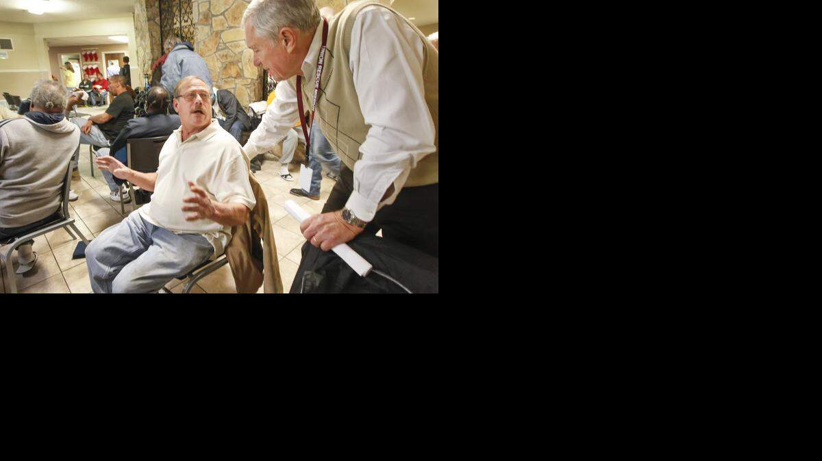 
Union Rescue Mission director Denny Bender, right, talks Wednesday with Gale Zuern, who has been a resident there on and off for two years. Zuern was telling Bender how he finally found housing through Veterans Affairs. (Dec. 3, 2014)
