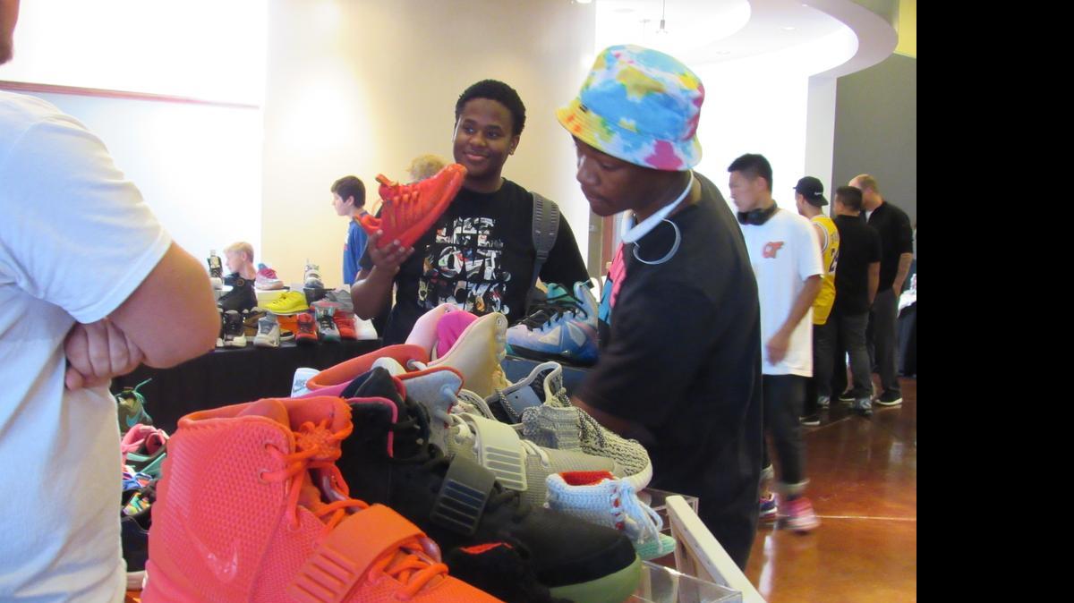 
Bryce Johnson, center and his friend Brittain Gill bargain for sneakers Saturday at Sole Purpose 2. (July 18, 2015)
