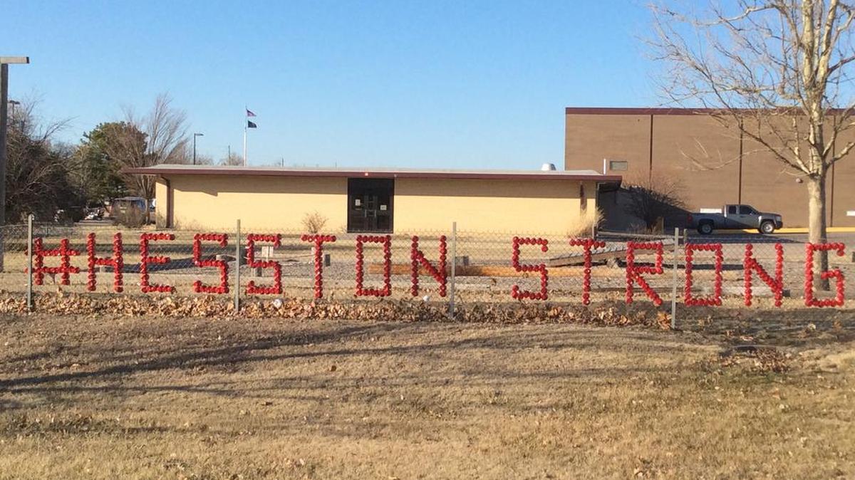 A #HesstonStrong sign hangs on a fence between Hesston Middle School and Excel Industries on Saturday.
