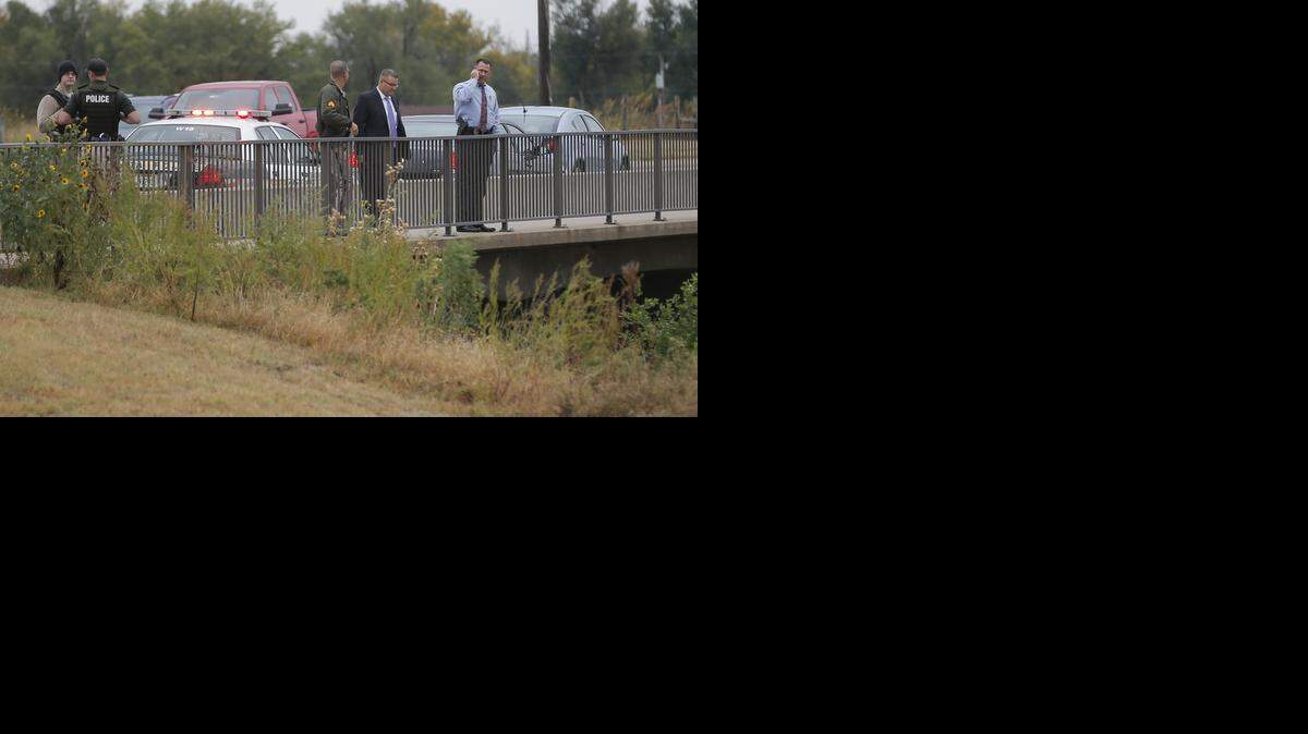 
Wichita police officers and detectives work the scene where the body of a female was found under the bridge near the Big Ditch near Central and Ridge on Friday afternoon. (Oct. 10, 2014)
