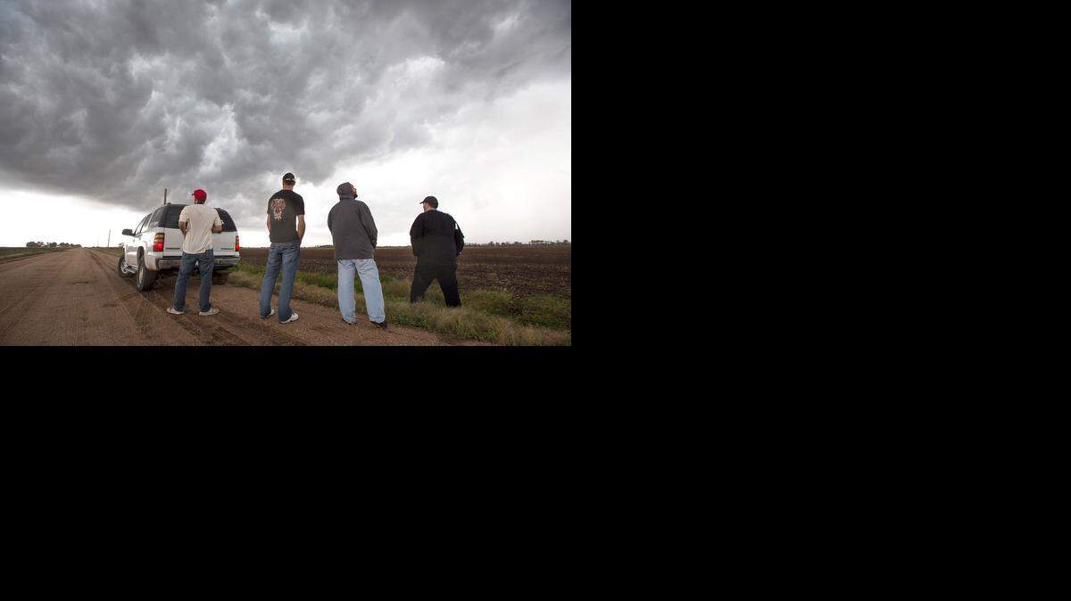 
A group of storm chasers from Topeka watch ominous skies near Mulvane while severe weather moves into the area in 2012.
