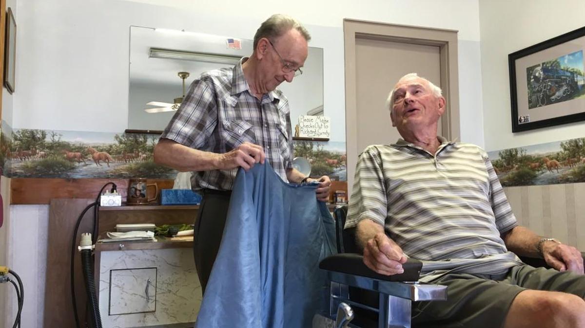 Richard Lundy chats with a longtime client in his barbershop on East Central.
