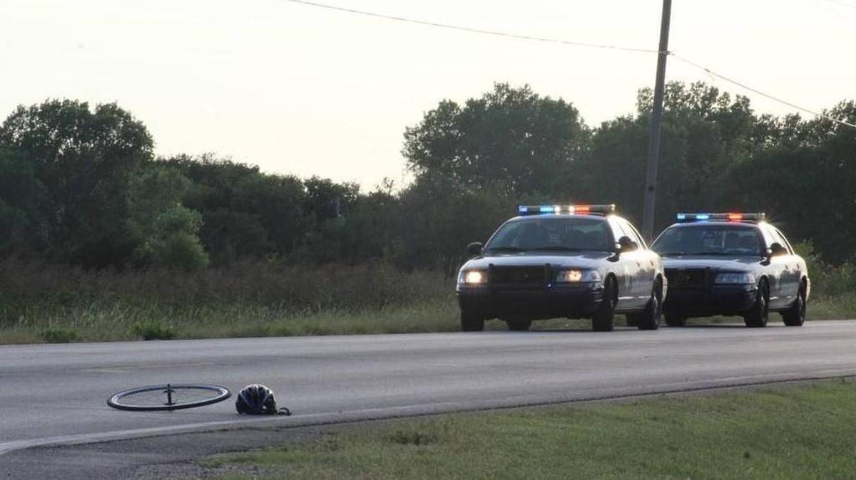 
A wheel and a helmet sit on MacArthur Road after a bicyclist was hit by a truck late Friday afternoon. The bicyclist later died. (Sept. 4, 2015)
