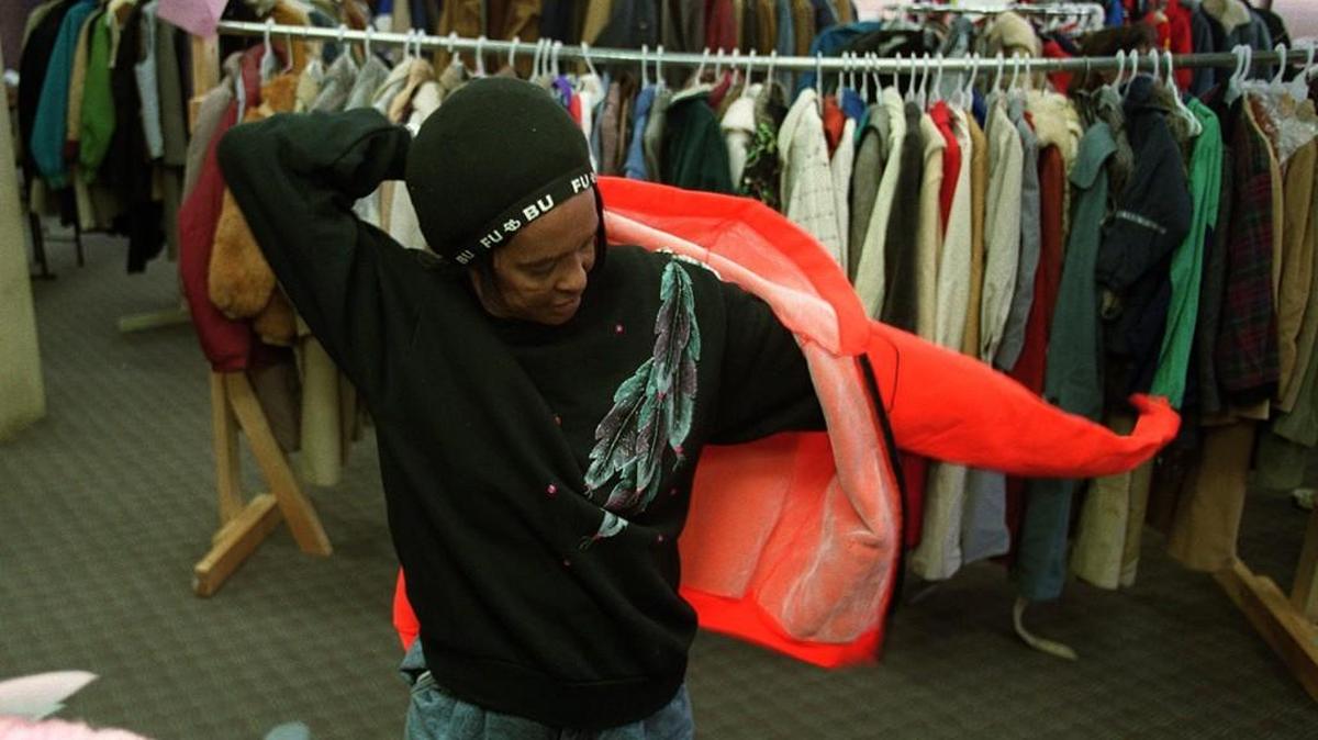Mary Austin tries on a coat at the Salvation Army during a past coat drive.