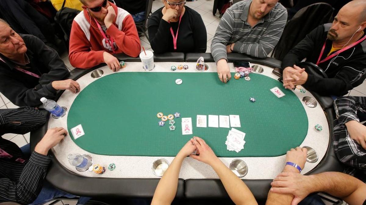 Participants play a hand during Cards for the Cure in 2014. Poker tournaments set for Jan. 30 were canceled after organizers were told the Hyatt could no longer host the event because it violates the state’s gambling law.