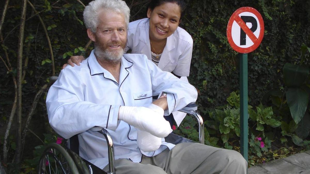 Glenn Nyberg with a nurse at a hospital in Kathmandu, Nepal, after he became ill during a Himalayan climbing trip.