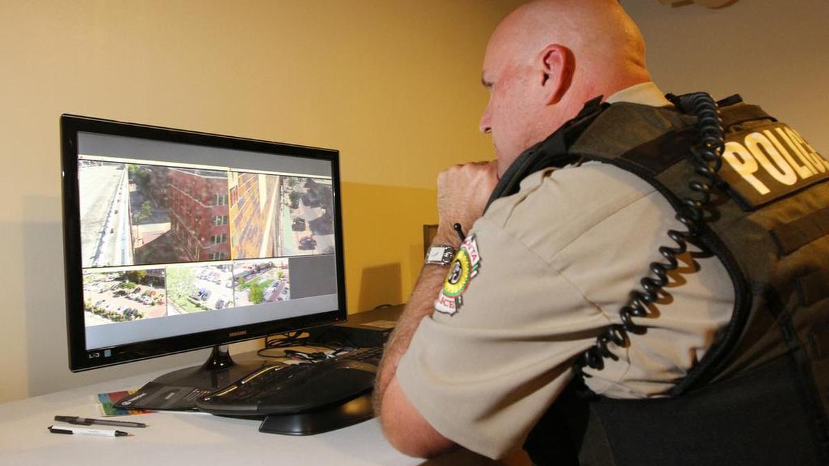 A Wichita police officer looks at security camera feeds in the Old Town substation in 2013.