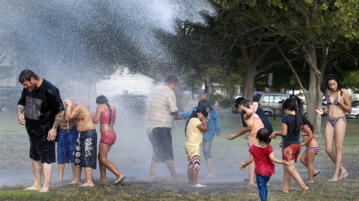 A firetruck sprays people at a National Night Out block party at Lincoln Park in 2011.