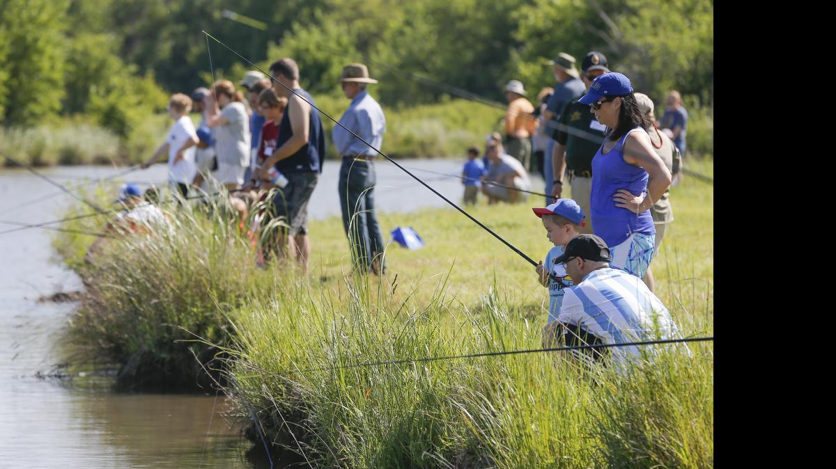 
Kids, parents and volunteers cast several lines into the water Saturday during The Wichita Eagle’s Kids Fishing Clinic at the Great Plains Nature Center. (June 20, 2015)
