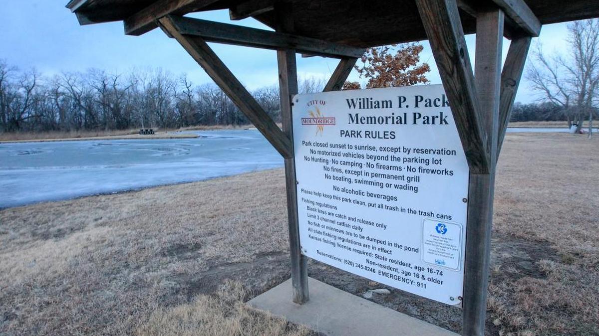 A rules sign at the icy pond at Pack Park in Moundridge, where Polly Claassen, 44, and her son, Trent, 8, died after falling through the ice. A new rule will prohibit people from getting on the ice, an official says. (Jan. 10, 2017)